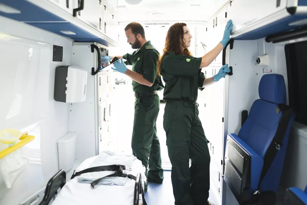 paramedic-team-checking-equipment-ambulance