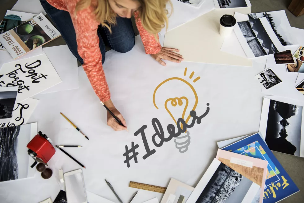 woman-writing-hashtag-ideas-paper