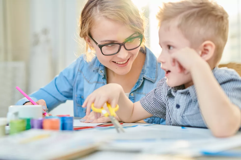 happy-mother-son-crafting-together-sunlight