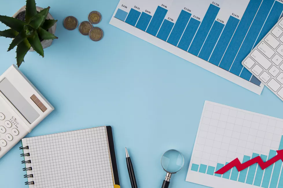 top-view-office-desk-with-growth-chart-coins