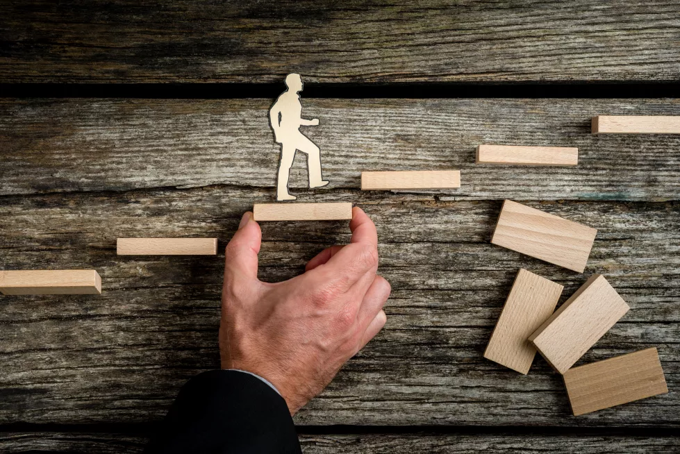 teamwork-concept-with-businessman-holding-up-stairs