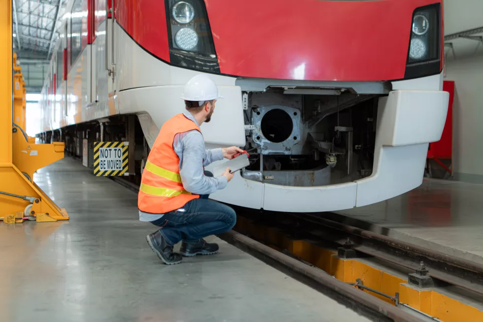 portrait-young-male-technician-using-tablet-working-standing-skytrain-repair-station