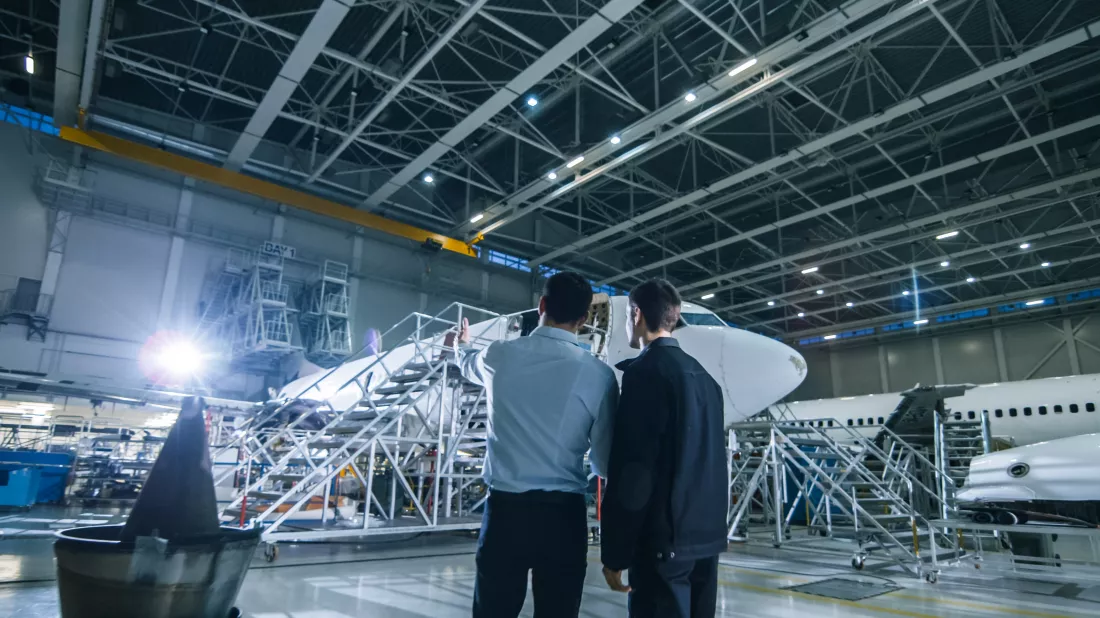 aircraft-maintenance-worker-engineer-having-conversation-looking-airplane