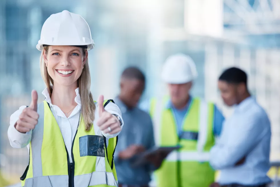 portrait-thumbs-up-construction-with-designer-woman-outdoor-building-site-with-her-team-background-management-motivation-confidence-with-female-architect-standing-outside