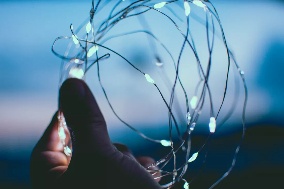 close-up-hand-holding-illuminated-string-light