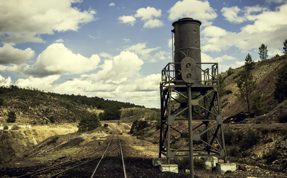 old-train-tracks-mining-landscape-with-traffic-light-water-tank-side
