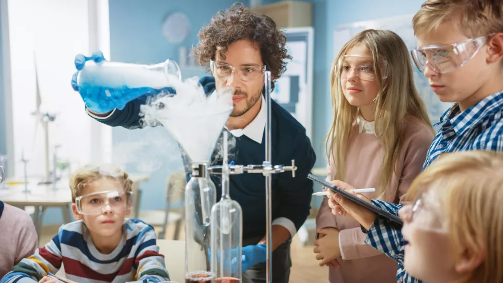 teacher-is-working-with-group-students-science-lab
