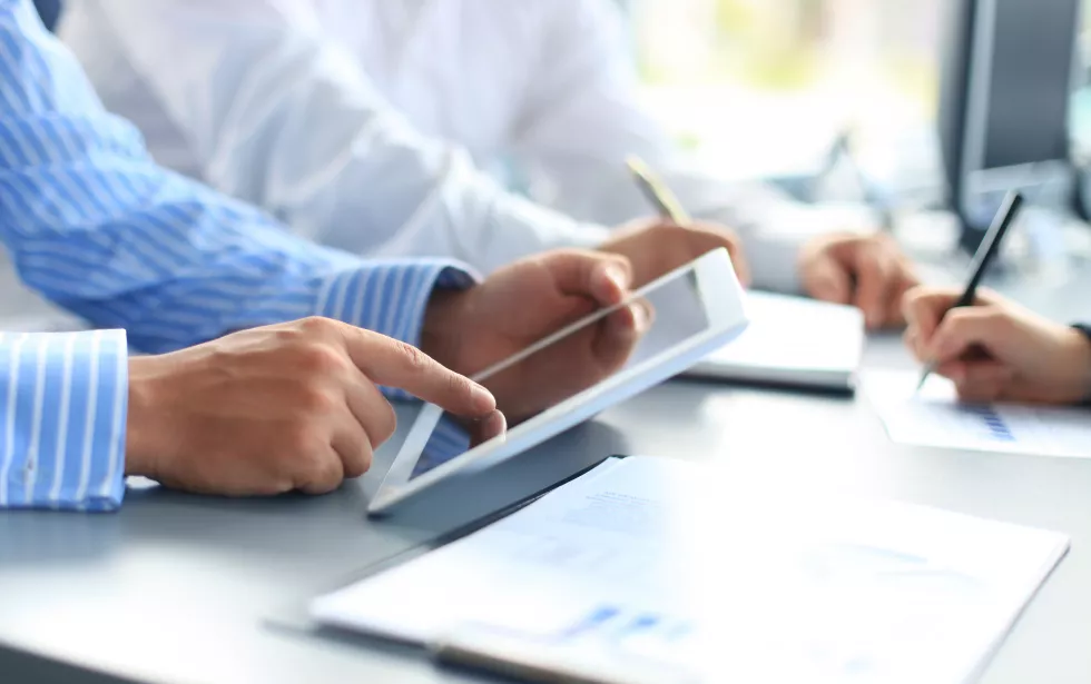 unrecognizable-business-person-analyzing-graphs-taking-notes