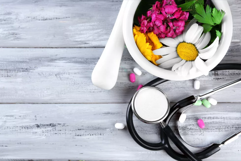 alternative-medicine-herbs-berries-stethoscope-wooden-table-background