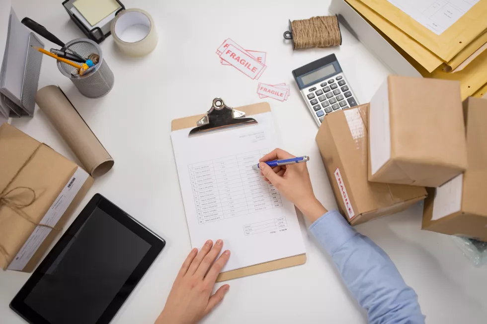 woman-with-parcels-clipboard-post-office