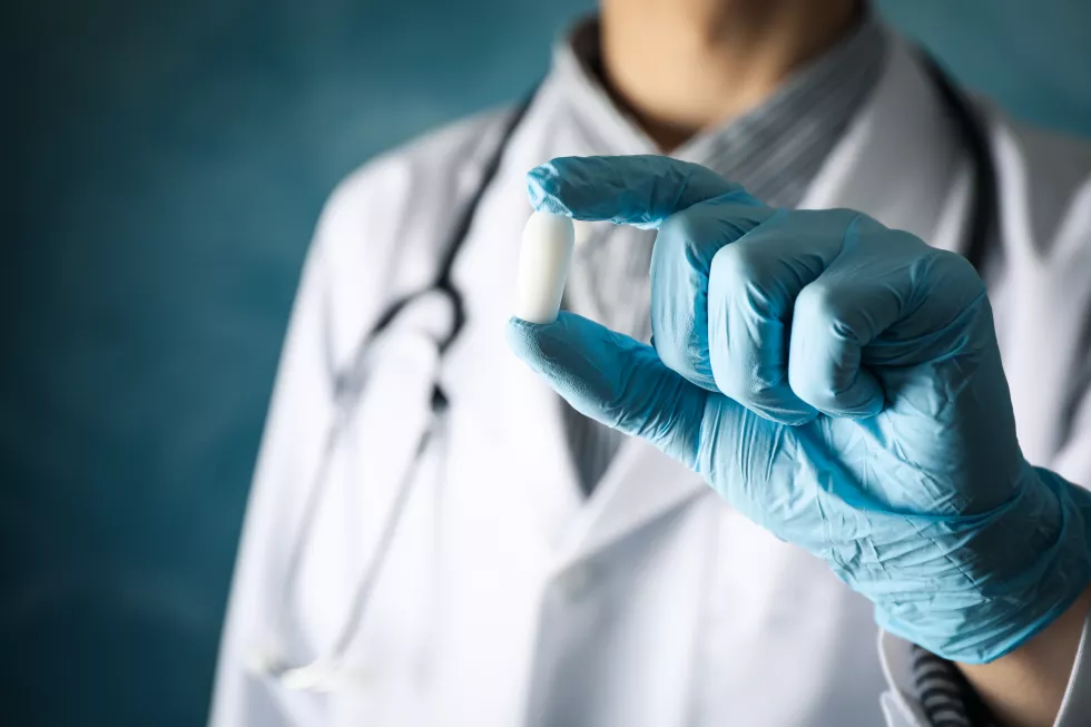 doctor-hold-anal-vaginal-candle-blue-close-up