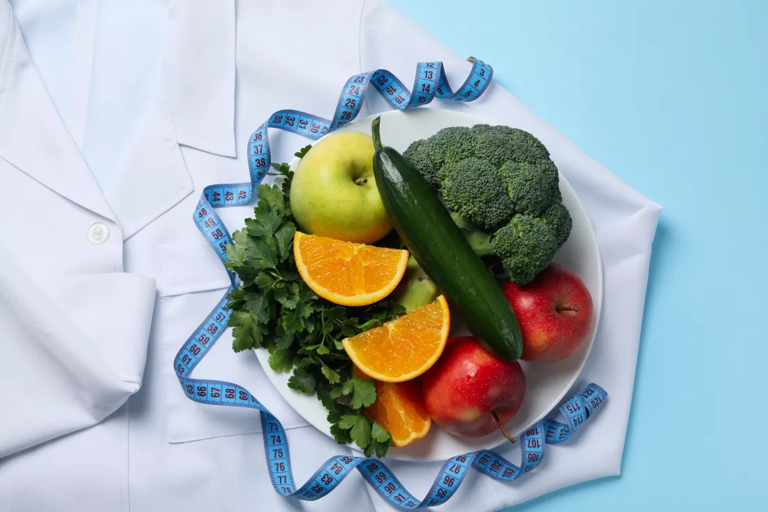 doctors-coat-healthy-food-measuring-tape-blue-background-weight-loss