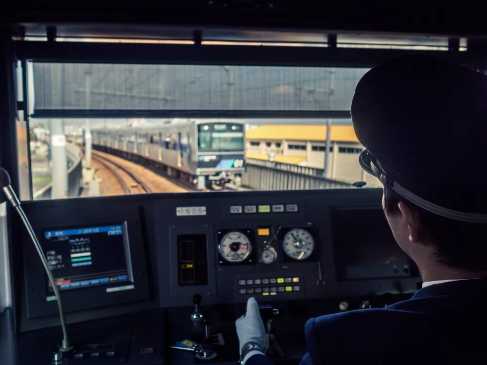 rear-view-man-driving-train