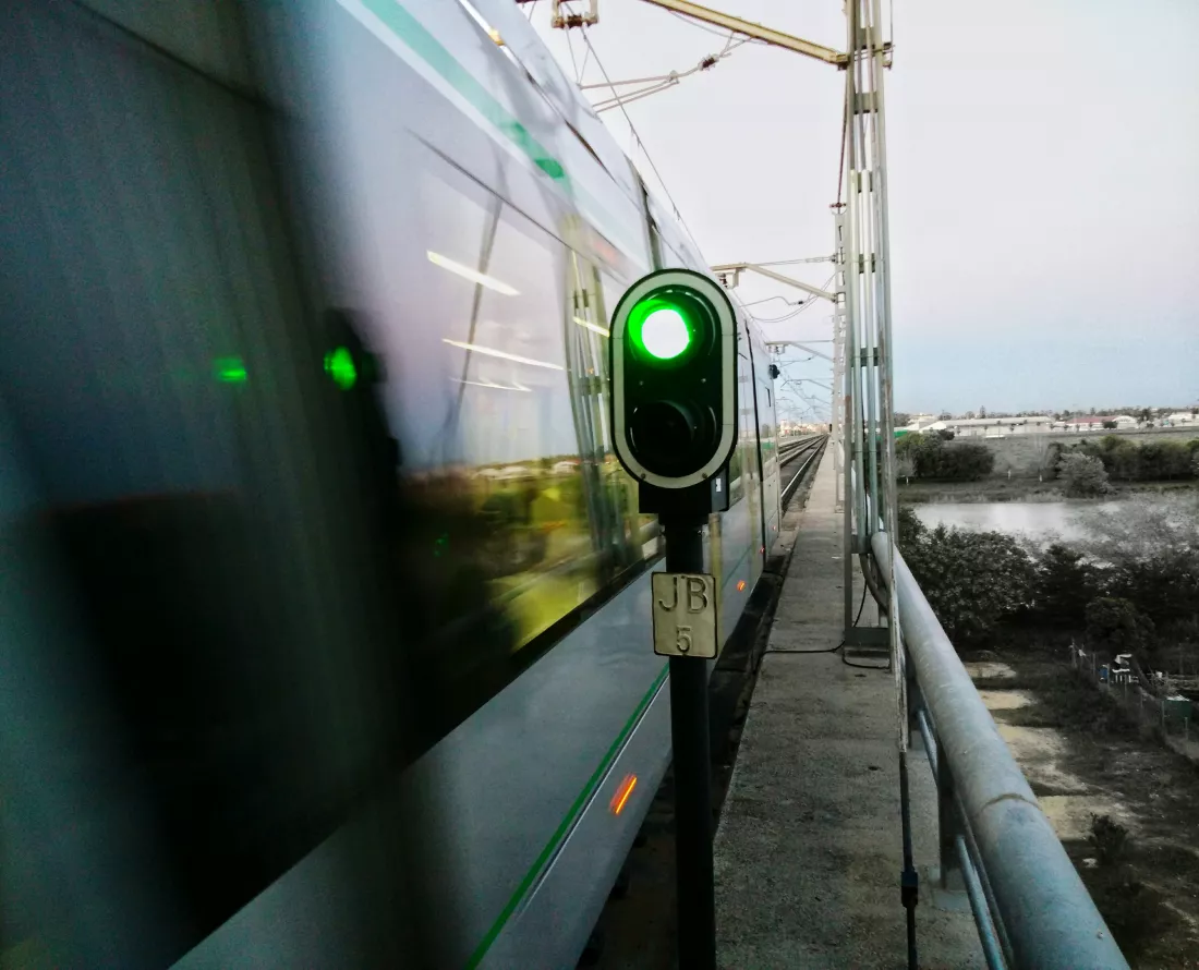 train-by-railroad-signal-against-sky