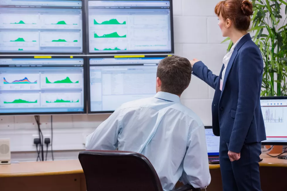 focused-colleagues-analyzing-result-their-computer